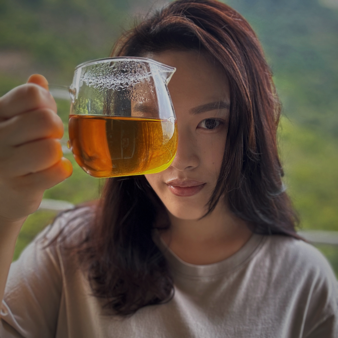 Photo of Clara who founded Purring Lotus holding a pitcher of tea