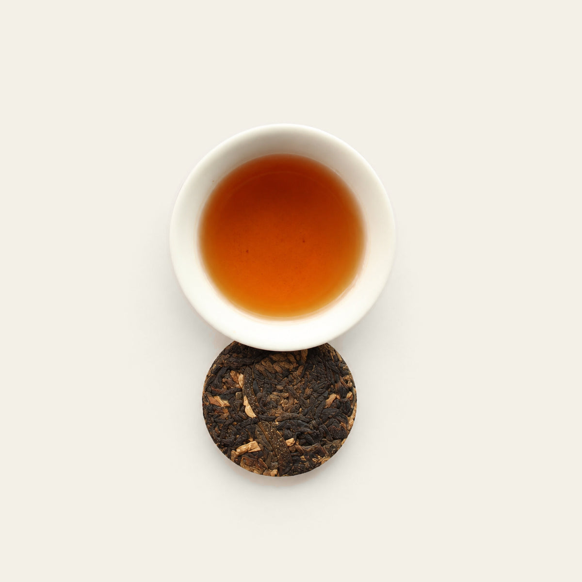 Green tangerine black tea liquor with dry cake