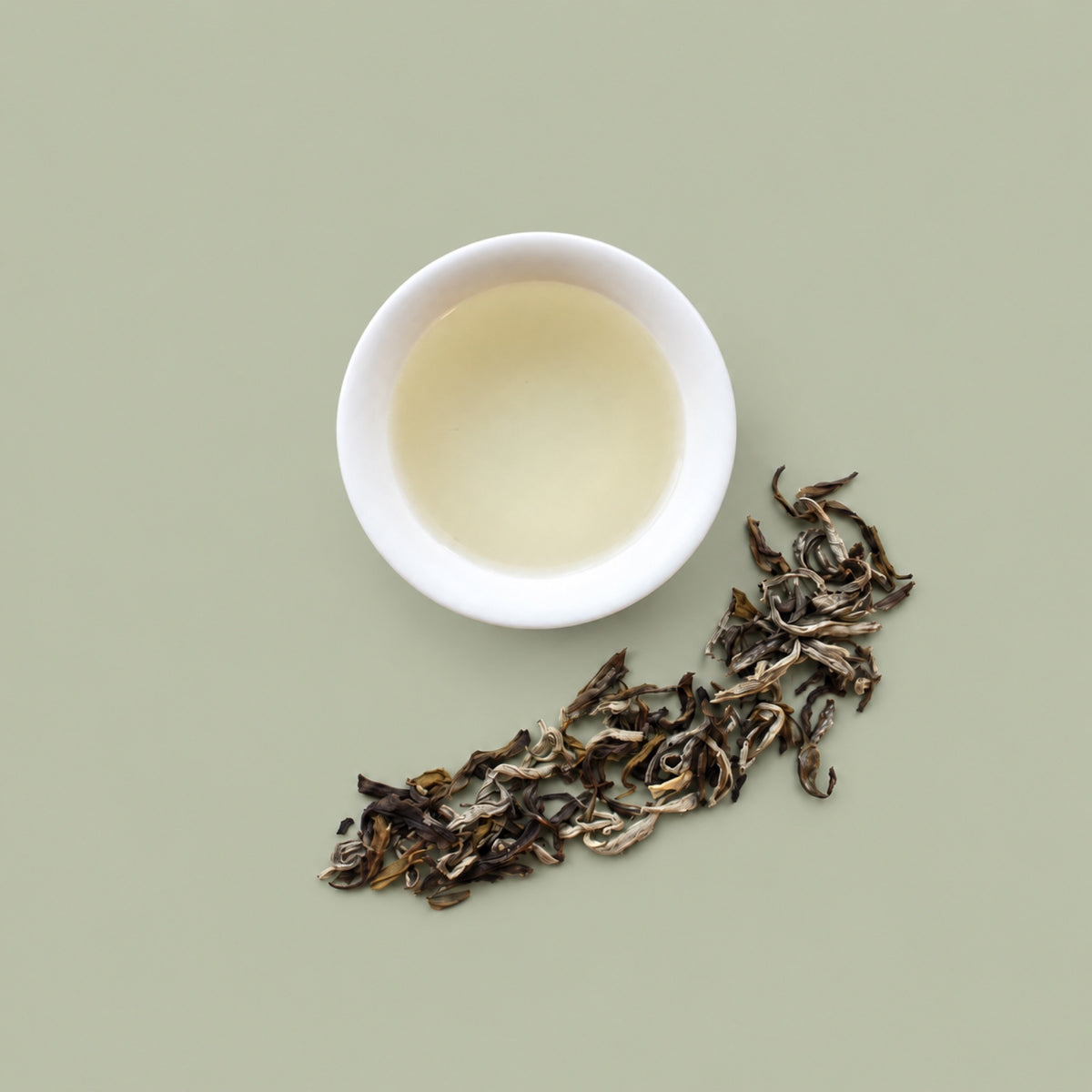 Jasmine tea liquor with dry leaves