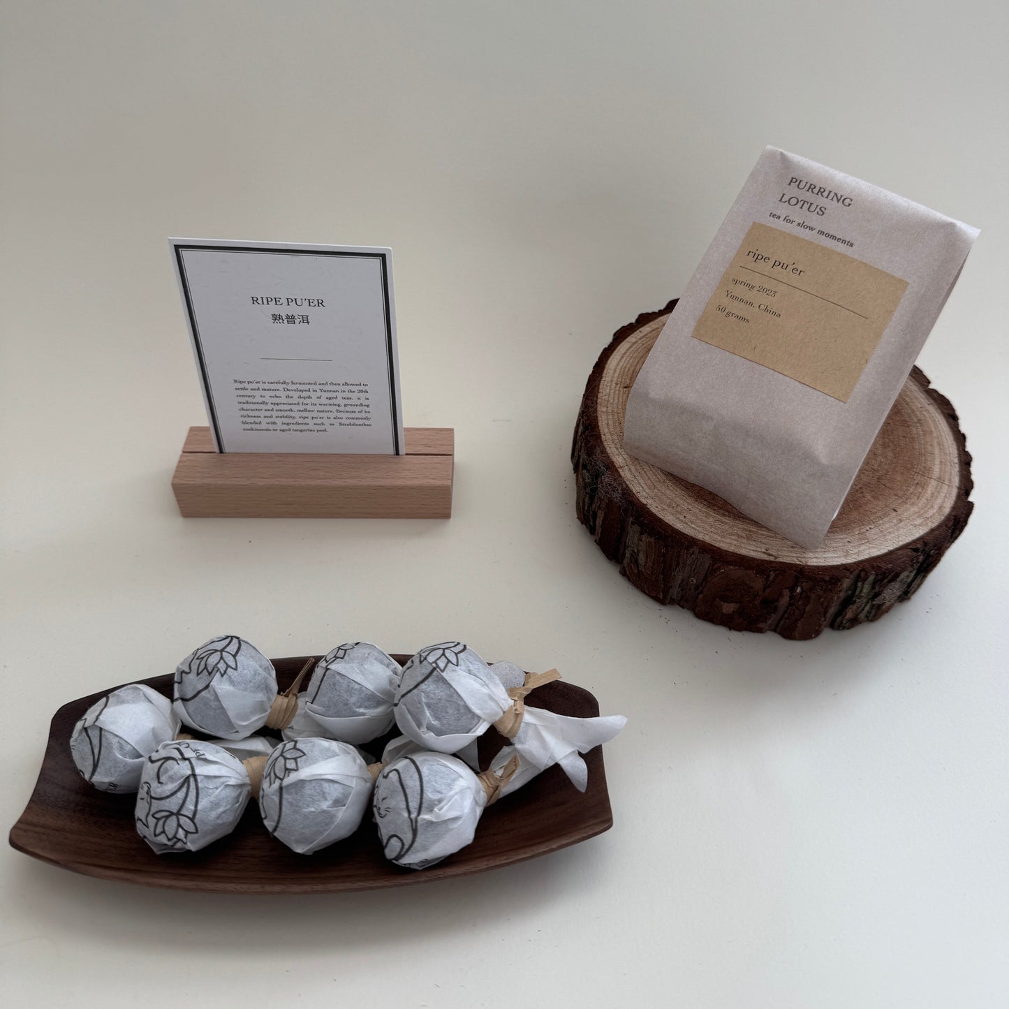Ripe pu'er dragon balls with tea card and packaging.